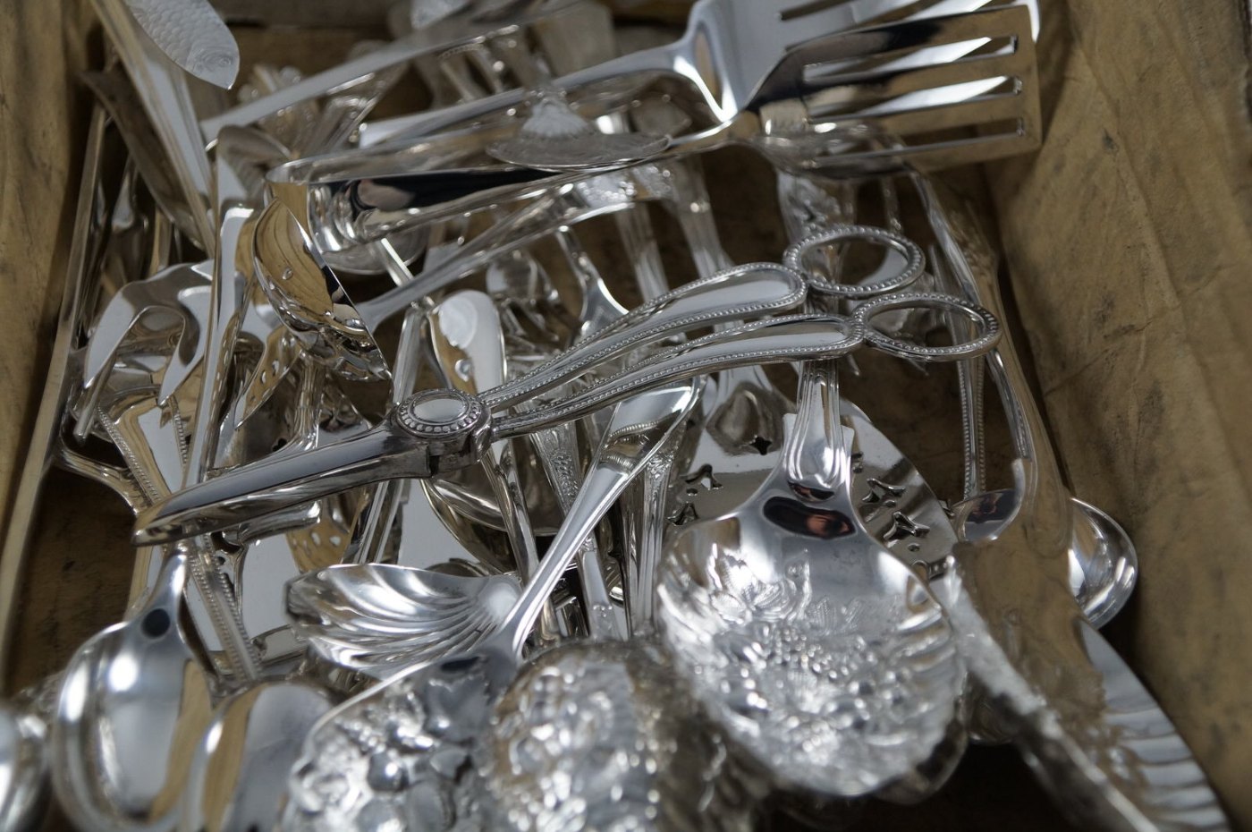 The same box of silverware after polishing and re-plating